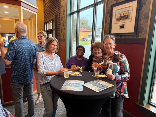 Guests gathered around a cocktail table at the annual meeting
