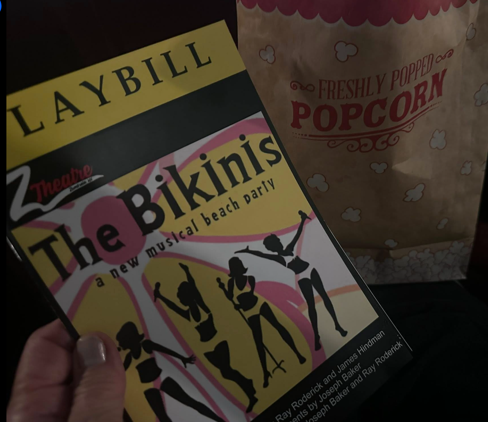 The Bikini musical program beside freshly popped popcorn