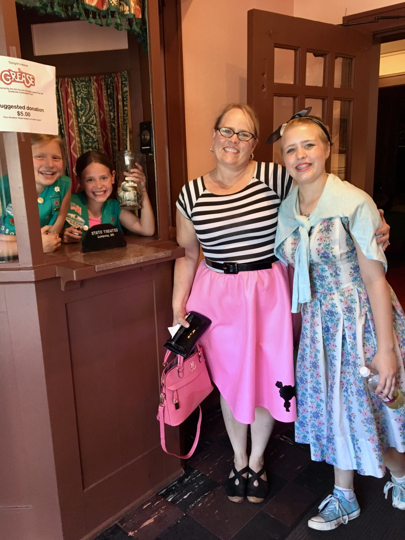 Community group posing together at the theatre entrance