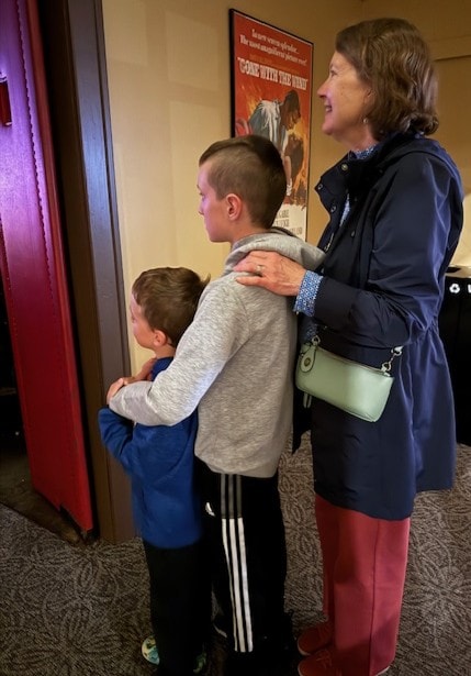 Family visiting the theatre together near the doorway