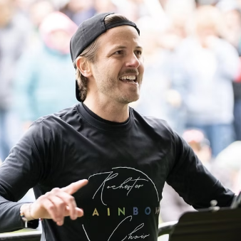 Rainbow Choir conductor at a live event