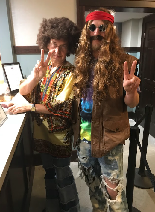 Two performers in colorful retro-inspired costumes